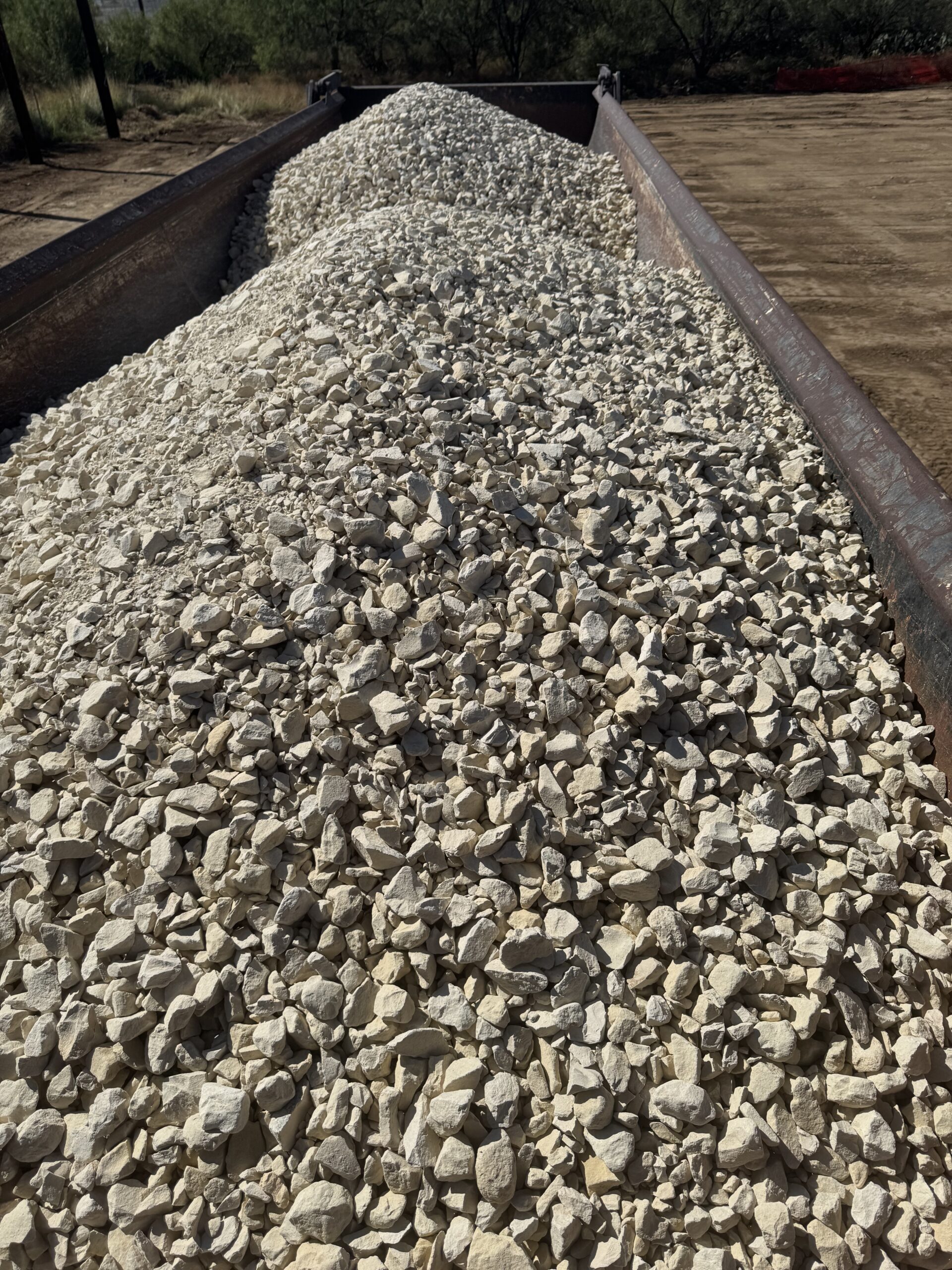 Truck loaded with 2-inch limestone base heading to a substation.