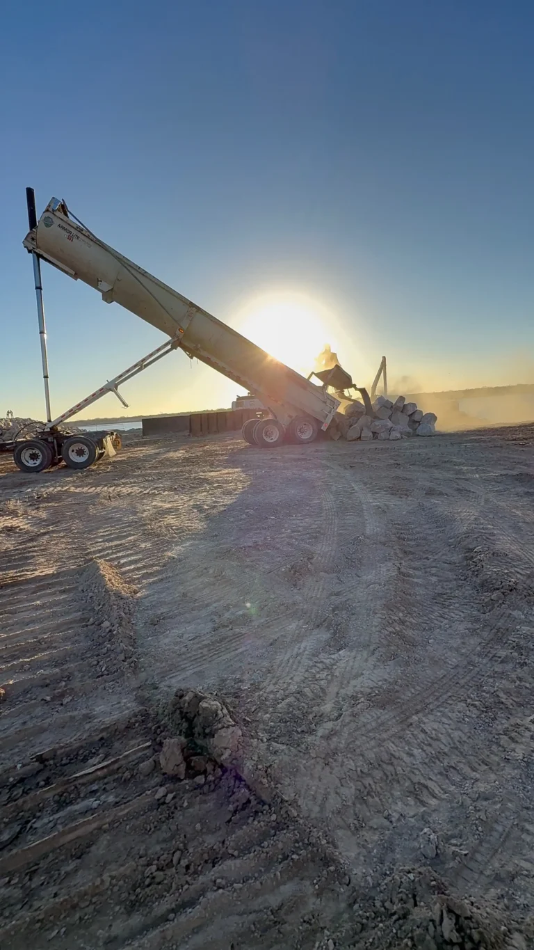 End dump unloading riprap material on a jobsite