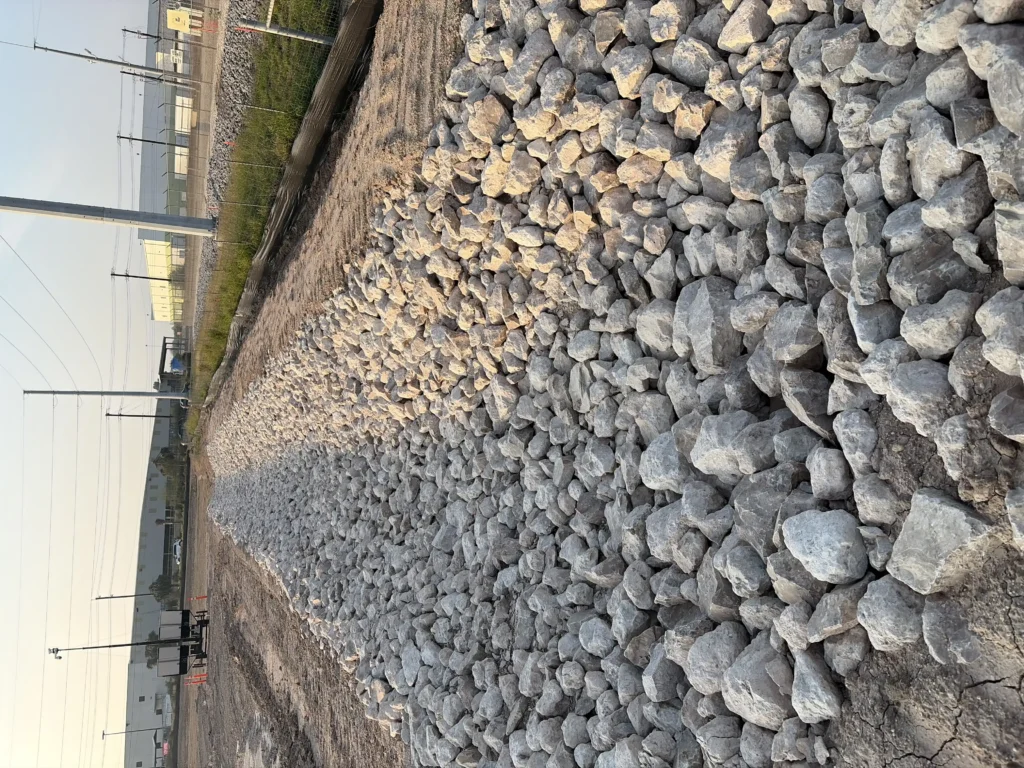 Drainage system on a project. The bigger rock helps keep the shape of the ditch from falling apart.